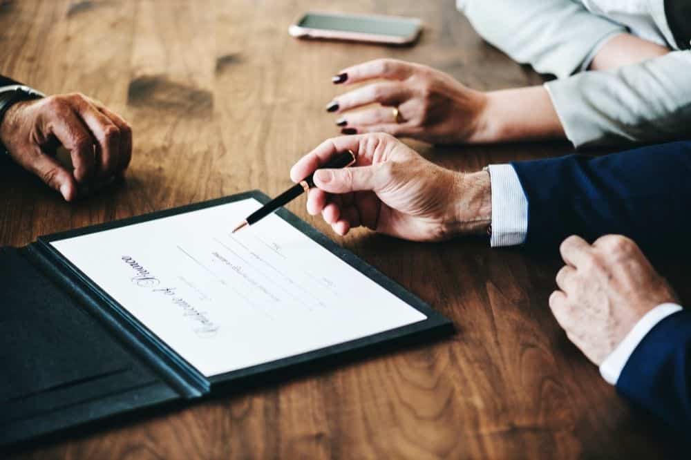 Lawyer meets with a married couple to sign the divorce